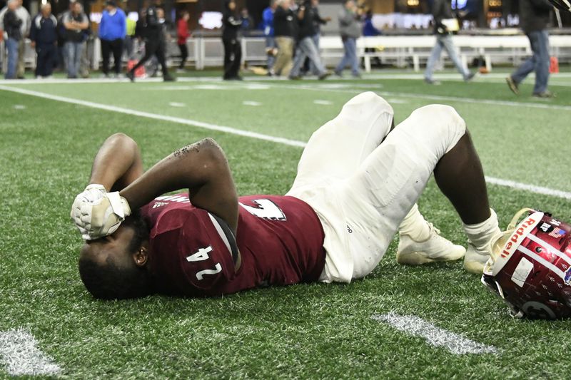 Warner Robins player Jahlen Rutherford lays dejected after their class 5A high school championship football game against Bainbridge, Tuesday, Dec., 11, 2018, at Mercedes-Benz Stadium, in Atlanta. Bainbridge won 47-41 in 3 overtimes. (John Amis/Special)