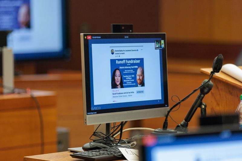 An advertisement for a runoff fundraiser featuring Fulton County District Attorney Fani Willis and lieutenant governor candidate Charlie Bailey is seen on monitors at the Fulton County Superior Court on Thursday, July 21, 2022. (Arvin Temkar / arvin.temkar@ajc.com)