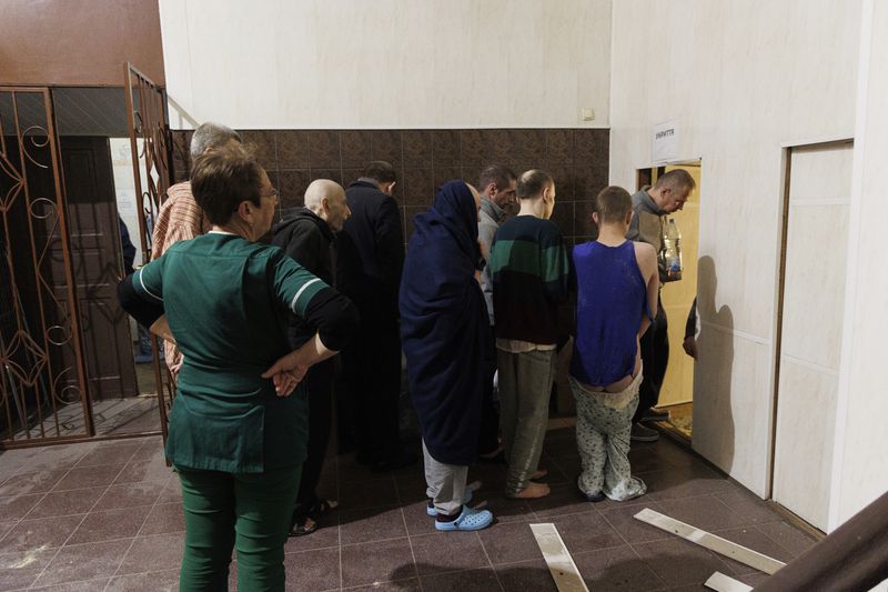Patients down to the shelter to take cover after a Russian rocket attack on mental hospital №3 in Kharkiv, Ukraine, Saturday, April 27, 2024. (AP Photo/Yakiv Liashenko)