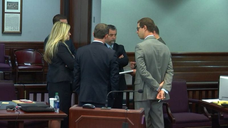 Prosecution and defense lawyers spend part of the lunch break to discuss how jurors will be allowed to view the SUV of Justin Ross Harris, during Harris' murder trial at the Glynn County Courthouse in Brunswick, Ga., on Wednesday, Oct. 26, 2016. (screen capture via WSB-TV)