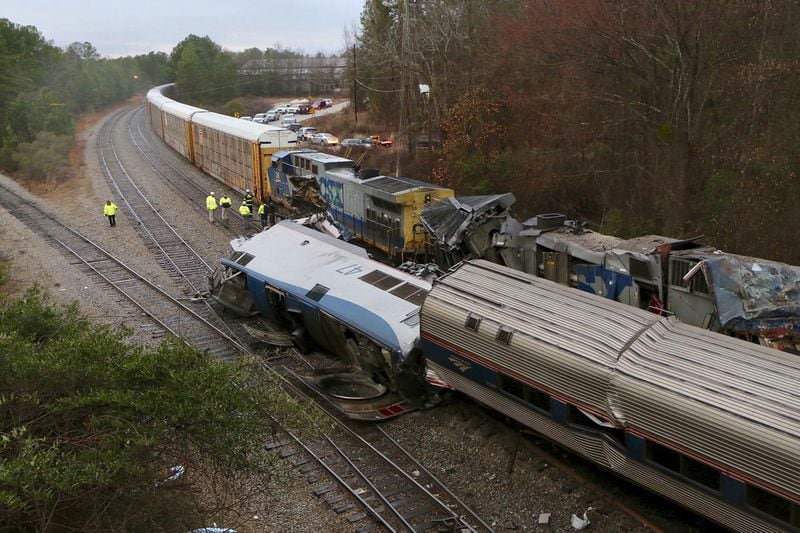 Authorities investigate the scene of a fatal Amtrak train crash in Cayce, S.C., Sunday, Feb. 4, 2018. At least two were killed and dozens were injured. (Tim Dominick/The State via AP)
