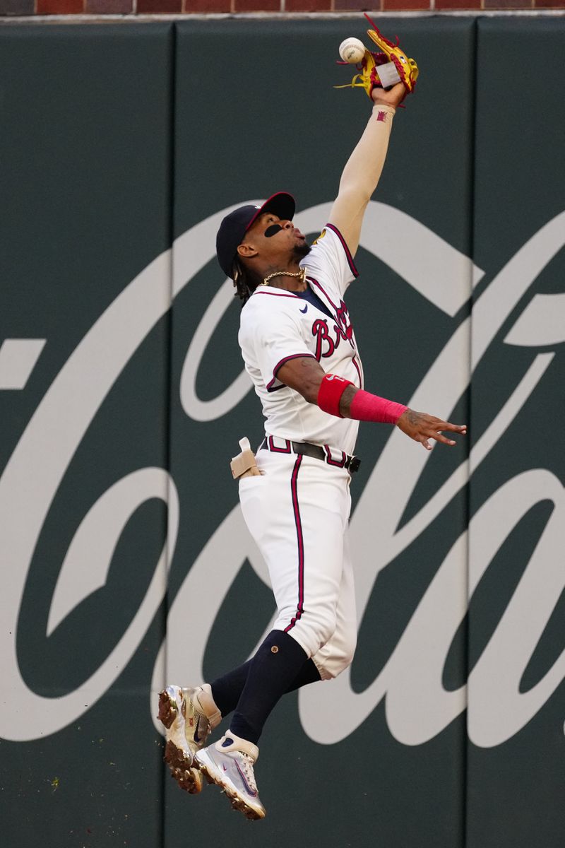 A flyball from Miami Marlins' Emmanuel Rivera gets past Atlanta Braves outfielder Ronald Acuña Jr. for a double in the third inning of a baseball game Wednesday, April 24, 2024, in Atlanta. (AP Photo/John Bazemore)