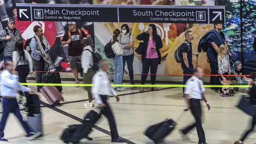 May 25, 2023 Hartsfield-Jackson International Airport: Here travelers surge at the South Terminal inside the airport Thursday morning, May 25, 2023. (John Spink / John.Spink@ajc.com)