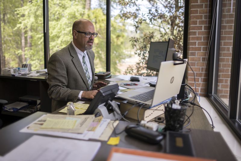 East Georgia State College President David Schecter works at his desk on campus.  (Stephen B. Morton for The Atlanta Journal-Constitution)