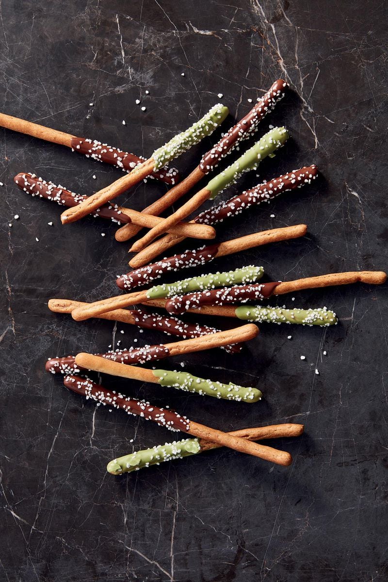You can get creative with glazes and decorations for Chocolate-Tipped Cream Puff Pocky Sticks, found in “Baking With Dorie” by Dorie Greenspan (Mariner, $35). (Courtesy of Mark Weinberg)