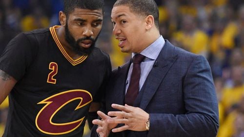Cleveland Cavaliers head coach Tyronn Lue talks with guard Kyrie Irving (2) against the Golden State Warriors during the first quarter in game five of the 2017 NBA Finals at Oracle Arena.