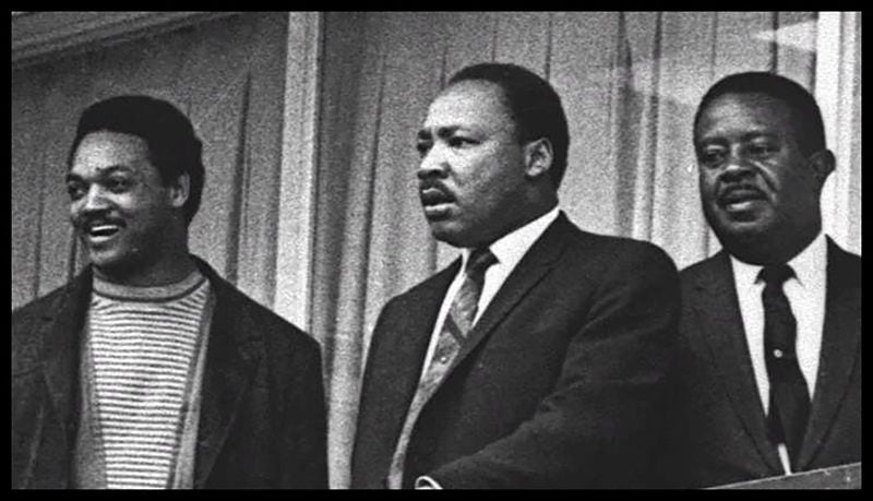 Martin Luther King Jr., with Jesse Jackson and Ralph David Abernathy, stands on the balcony of the Lorraine Motel in Memphis, Tenn., on April 3, 1968, the day before he was assassinated there. (AP Photo/File)