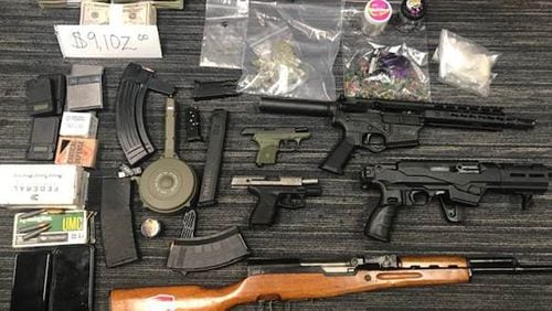Three people were arrested Monday after police said they seized cocaine, money and a cache of stolen weapons from a South Fulton condominium.