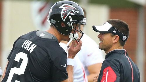 Falcons quarterbacks coach Matt LaFleur confers with Matt Ryan during team practice Wednesday in Flowery Branch.