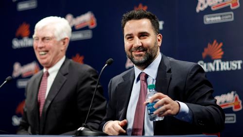 Alex Anthopoulos, right, speaks at a news conference introducing him as the new general manager of the Atlanta Braves baseball team by Terry McGuirk, chairman and CEO, in Atlanta, Monday, Nov. 13, 2017. (AP Photo/David Goldman)