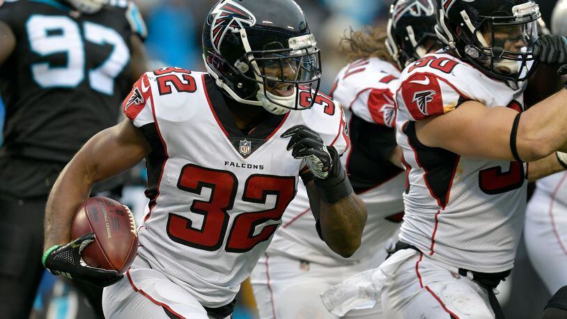 CHARLOTTE, NORTH CAROLINA - DECEMBER 23: Brian Hill #32 of the Atlanta Falcons runs the ball against the Carolina Panthers in the fourth quarter during their game at Bank of America Stadium on December 23, 2018 in Charlotte, North Carolina. (Photo by Grant Halverson/Getty Images)