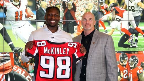 Falcons first pick Takkarist McKinley strikes a pose with coach Dan Quinn after the 2017 draft. (AtlantaFalcons.com)