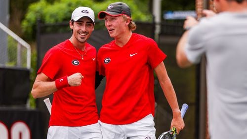 Georgia tennis players Thomas Paulsell (L), and Ethan Quinn celebrate winning n NCAA tournament match against Oklahoma in the second round May 7 at UGA's Dan Magill Tennis Complex. (Tony Walsh/UGA Athletics)
