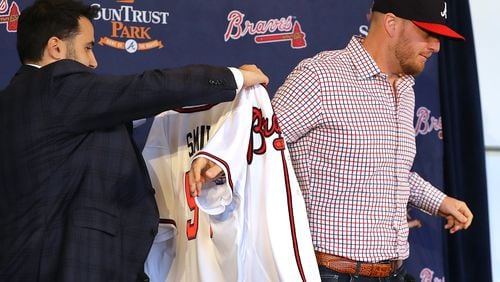 Braves General Manager Alex Anthopoulos gives left-handed pitcher Will Smith his new jersey.   Curtis Compton/ccompton@ajc.com