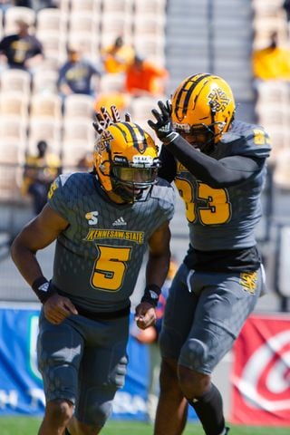 Tommy Bryant (left) and Cade Radam of Kennesaw State celebrate after a touchdown. Kennesaw State defeated Dixie State 37-27. CHRISTINA MATACOTTA FOR THE ATLANTA JOURNAL-CONSTITUTION.