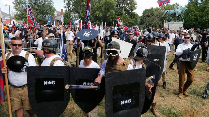 White nationalist demonstrators hold their ground as they clash with counter demonstrators in Lee Park in Charlottesville, Va. on Aug. 12, 2017.