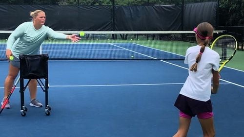 Coach Mel, as Melanie Oudin goes by now, works on a pupil's backhand. (Photo courtesy Melanie Oudin)