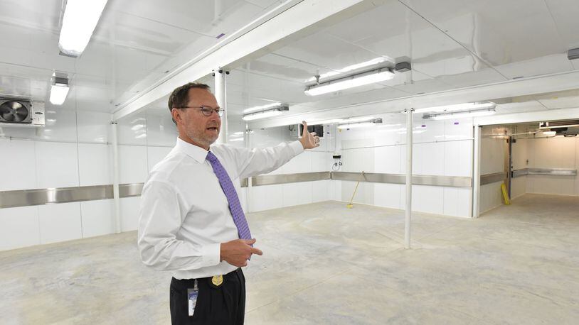 September 6, 2017 Decatur - J. Bahan Rich, Deputy Director of GBI Public Affairs Office, shows new morgue cooler in GBI Medical Examiner Annex on Wednesday, September 6, 2017. Bodies are stacking up at the state morgue. Soon it will more than double in size as workers complete an expansion but still the Georgia Bureau of Investigation struggles to get families to arrange for burial. HYOSUB SHIN / HSHIN@AJC.COM