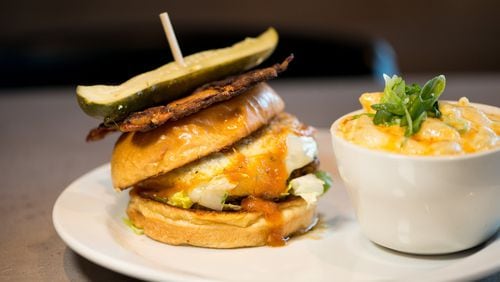 Hoyle's Kitchen and Bar signature Hoyle's Burger with lettuce, caramelized onion, woven bacon, provolone, and tomato jam. Photo credit- Mia Yakel.