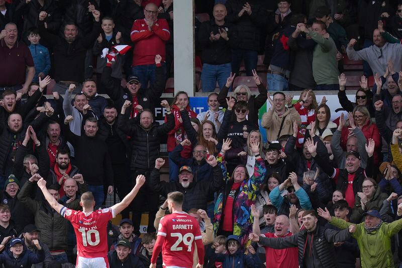 Wrexham's Paul Mullin, left, celebrates scoring their side's second goal of the game during the Sky Bet League Two match at the SToK Cae Ras, Wrexham, England, Saturday April 13, 2024. (Jacob King/PA via AP)