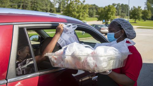 Clayton County Schools will distribute Thanksgiving meals to local residents at five schools Friday. (Alyssa Pointer / Alyssa.Pointer@ajc.com)