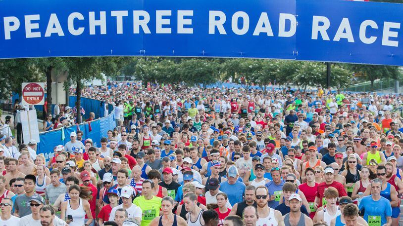 Runners cross the starting line during the 48th AJC Peachtree Road Race, Tuesday, July 4, 2017, in Atlanta.