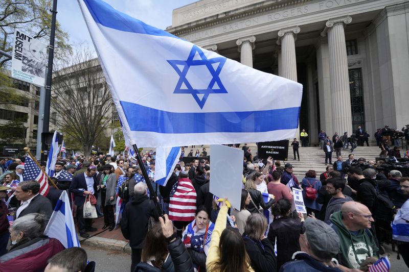 Pro-Israel protestors rally across the street from a pro-Palestinian student encampment on the campus of the Massachusetts Institute of Technology, Friday, May 3, 2024, in Cambridge, Mass. (AP Photo/Charles Krupa)
