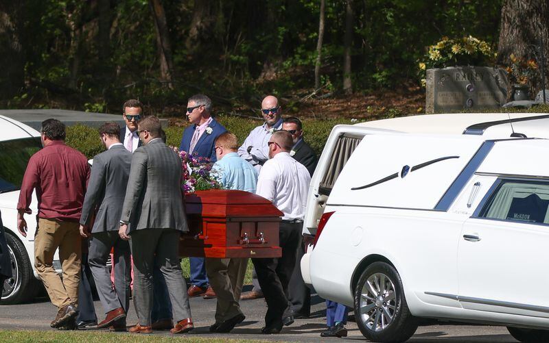 Pall bearers carry the casket of a Hawk family member on Thursday, April 14, 2022, in Newnan, Ga.  The Coweta family was killed during a gun shop robbery.   Branden Camp/For the Atlanta Journal-Constitution