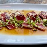 Seared tuna at Fudo is cut against the grain, revealing a vibrant pink interior and a tender, melt-in your mouth exterior. Angela Hansberger for The Atlanta Journal-Constitution