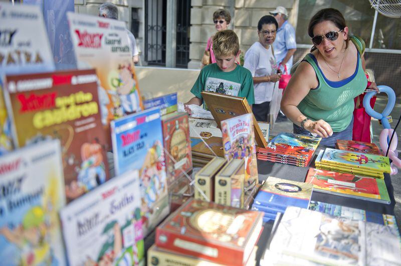 Rebekah Hart (right) and her son Jack look at books on Egyptology at one of the booths during last year's AJC Decatur Book Festival. JONATHAN PHILLIPS / SPECIAL