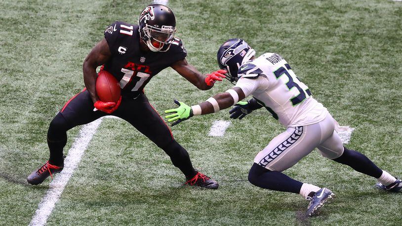 Falcons wide receiver Julio Jones makes a first-down catch against Seattle Seahawks strong safety Jamal Adams during the second half Sunday, Sept. 13, 2020, in Atlanta. (Curtis Compton / Curtis.Compton@ajc.com)