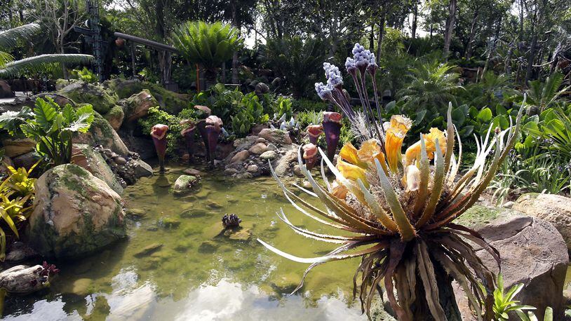 In this Saturday, April 29, 2017 photo, landscaping consisting of real Earth plant species mixed with sculpted Pandora flora surrounds a pond at the Pandora-World of Avatar land attraction in Disney's Animal Kingdom theme park at Walt Disney World in Lake Buena Vista, Fla. The 12-acre land, inspired by the âAvatarâ movie, opens in Florida at the end of May at Walt Disney Worldâs Animal Kingdom. It cost a half-billion dollars. (AP Photo/John Raoux)