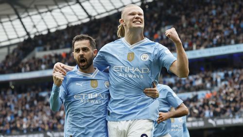 Manchester City's Erling Haaland, right, celebrates with Bernardo Silva after scoring his side's opening goal during the English Premier League soccer match between Manchester City and Wolverhampton Wanderers at the Etihad Stadium in Manchester, England, Saturday, May 4, 2024. (Richard Sellers/PA via AP)