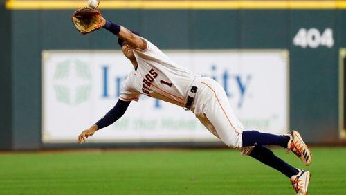 Houston Astros shortstop Carlos Correa catches a line drive by Washington Nationals' Howie Kendrick during the fourth inning of Game 1 of the baseball World Series Tuesday, Oct. 22, 2019, in Houston.