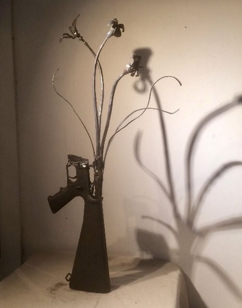 The finished product: An AR-15 as flowers in a vase. Photo by Bill Torpy