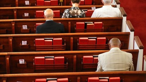 Members bow their heads for the opening prayer at Clarkston United Methodist Church on Sunday, Sept. 18, 2016. Curtis Compton / ccompton@ajc.com