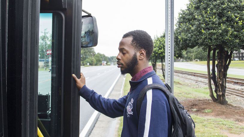 DeAngelo Bowie, 24, catches the bus to get to work. Bowie, 24, dropped out of Georgia State University in 2013 after a series of family health crises and financial problems derailed his dream of being a history teacher. Chad Rhym/ Chad.Rhym@ajc.com