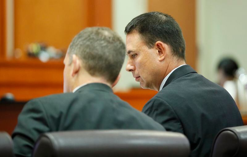 September 20, 2019 - Decatur - Prosecutor Pete Johnson (right) and Lance Cross confer during the hearing.   Judge LaTisha Dear Jackson, the judge overseeing the murder trial against former DeKalb police officer Chip Olsen holds a pretrial hearing to consider the defense's request to keep out evidence that victim Anthony Hill was mentally ill and an Afghan war vet. Bob Andres / robert.andres@ajc.com
