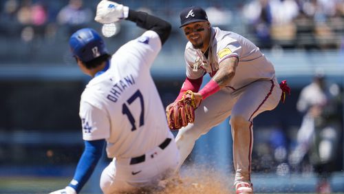 Los Angeles Dodgers designated hitter Shohei Ohtani is out at second ahead of a throw to Atlanta Braves shortstop Orlando Arcia, right, during the sixth inning of a baseball game against the Atlanta Braves in Los Angeles, Sunday, May 5, 2024. Freddie Freeman grounded in to a force out. (AP Photo/Ashley Landis)