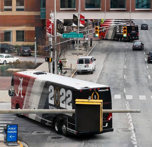 An Alabama team bus turns the corner ahead of the Georgia team hotel at the scene of the 2022 College Football Playoff National Championship  between the Georgia Bulldogs and the Alabama Crimson Tide at Lucas Oil Stadium in Indianapolis on Sunday, January 9, 2022.   Bob Andres / robert.andres@ajc.com