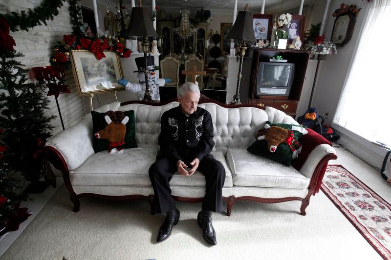 This photo taken Jan. 16, 2012, shows Ralph Stanley sitting on the couch in the living room of the Stanley home outside of Coeburn, Va., Monday, Jan. 16, 2012. Ralph Stanley died Thursday, June 23, 2016. He was 89. (Bob Brown/Richmond Times-Dispatch via AP)