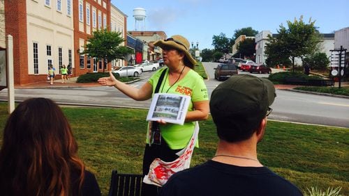 Tour guide Christina Tracy walks fans through the streets of Senoia, a primary location for the hit AMC TV series “The Walking Dead.” Photo credit: Jon Waterhouse