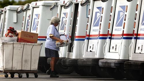 A mail carrier loads a truck for delivery at a United States post office. (TNS)