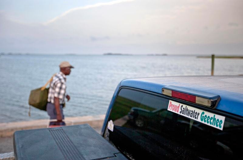 A sticker celebrating the Geechee heritage is seen on a pickup truck as passengers board a ferry to the mainland from Sapelo Island. One of the few remaining Gullah Geechee communities in the U.S. is in another fight to hold onto land owned by residents' families since their ancestors were freed from slavery. The few dozen remaining residents of the tiny Hog Hammock community on Georgia's Sapelo Island were stunned when they learned county officials may end zoning protections enacted nearly 30 years ago to protect the enclave from wealthy buyers and tax increases. (AP Photo/David Goldman, File)