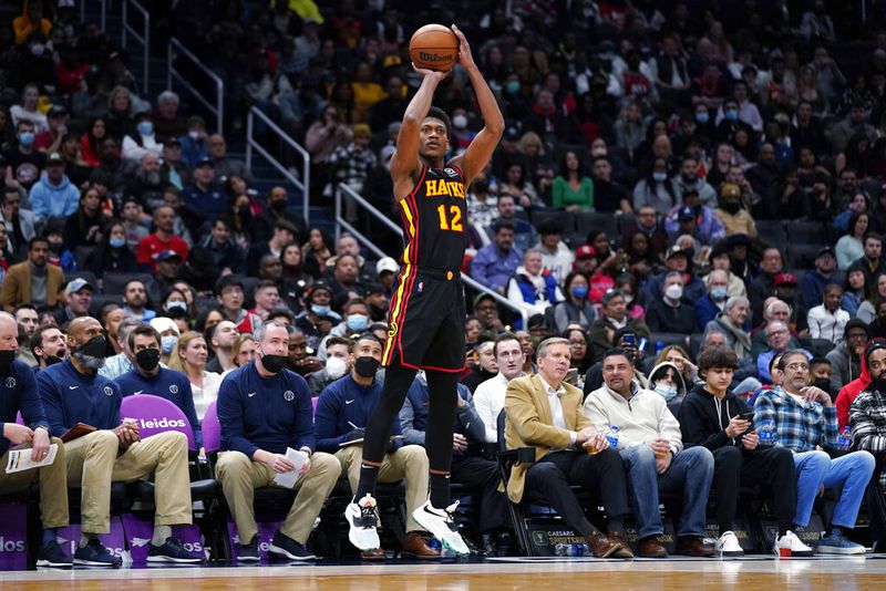 Atlanta Hawks forward De'Andre Hunter hits a 3-point shot during the second half of the team's NBA basketball game against the Washington Wizards, Friday, March 4, 2022, in Washington. The Hawks won 117-114. (AP Photo/Evan Vucci)