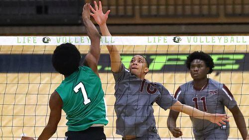 Morehouse College outside hitter Bryce Pretlow goes to the net against Life University right side hitter Jakaris Brown with teammate Williams Babalola also defending during a set in their volleyball match Feb. 16 in Marietta. (Curtis Compton / Curtis.Compton@ajc.com)