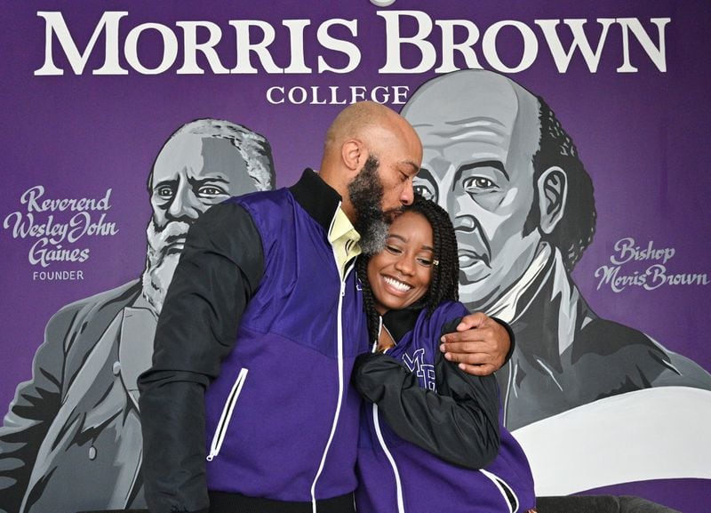 Morris Brown alumnus Jeffery Miller and his daughter and incoming student Nala Sarabi Miller share a smile after they worn school jackets at Morris Brown College on Wednesday, April 21, 2021. (Hyosub Shin / Hyosub.Shin@ajc.com)