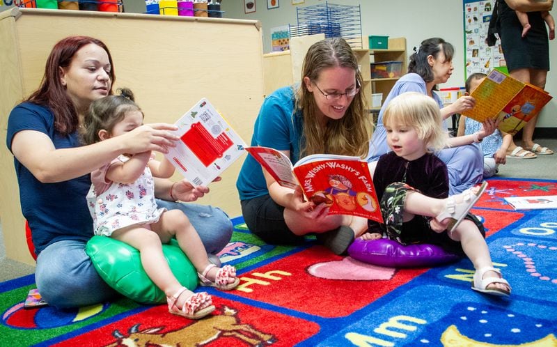 Mothers read to their children at B.B. Harris Elementary school in Duluth Friday May 13, 2022. (Steve Schaefer / steve.schaefer@ajc.com)