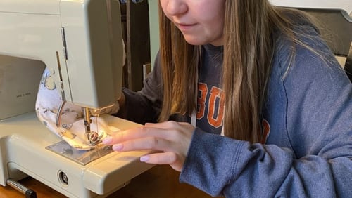 Bryn Hammock works on her "Tiny Hugs" project. These fabric gloves filled with weighted beads are used to comfort newborns in the neonatal intensive care unit when their parents cannot be with them. Courtesy of Bryn Hammock