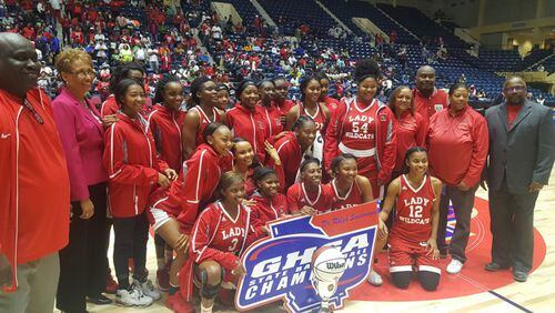 The Laney Lady Wildcats pose with the championship trophy following their 63-40 win over Josey in the Class AA championship at the Macon Centreplex on Wed., March 7, 2018.